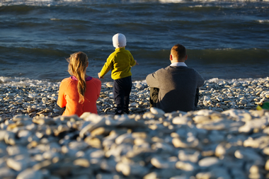 Family of three on pebble beach sbi 300930843